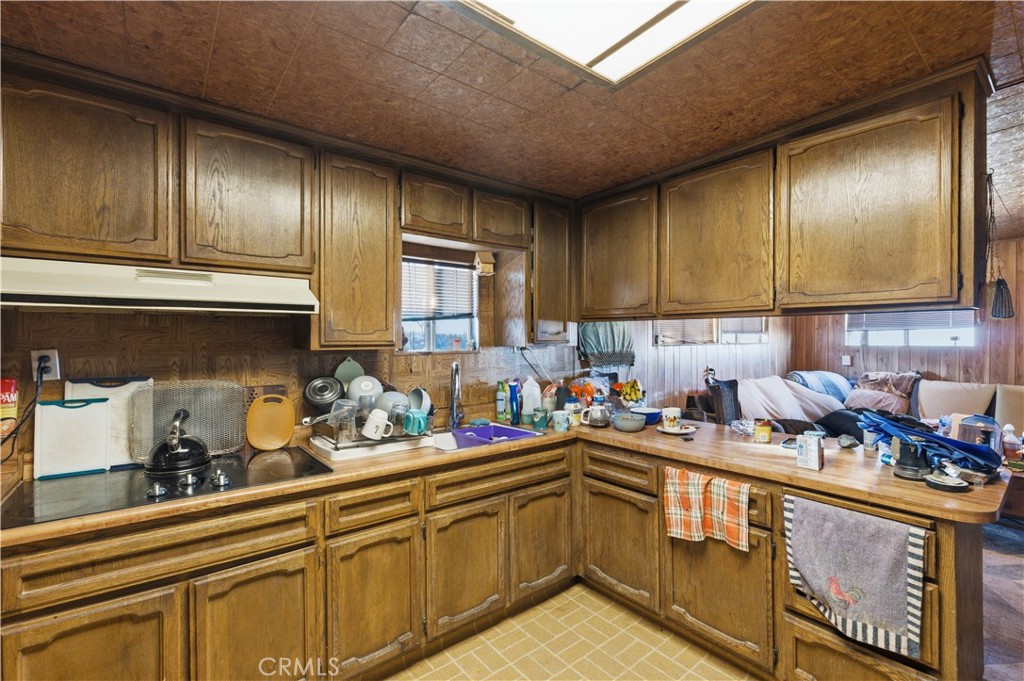 32787 Jagadon Road Lucerne Valley, CA 92356 - Photo 9 of 32 a kitchen with stainless steel appliances granite countertop a sink stove and cabinets