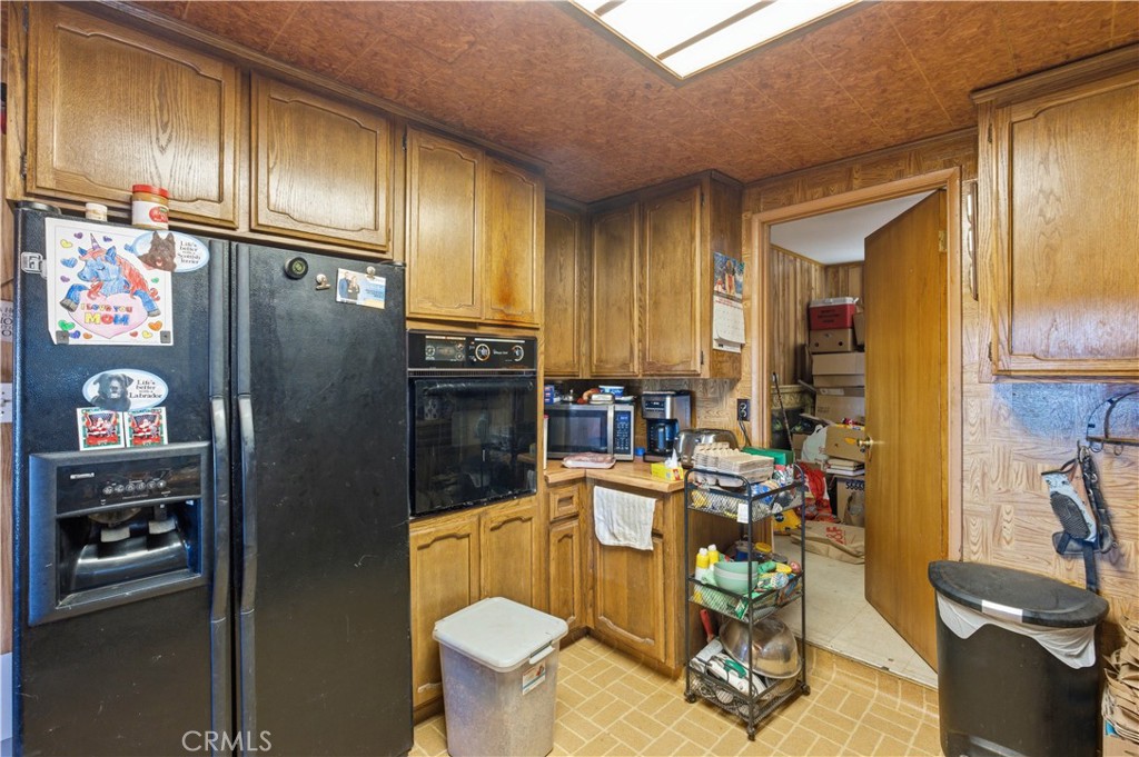 32787 Jagadon Road Lucerne Valley, CA 92356 - Photo 10 of 32 a kitchen with stainless steel appliances granite countertop a refrigerator and a stove top oven