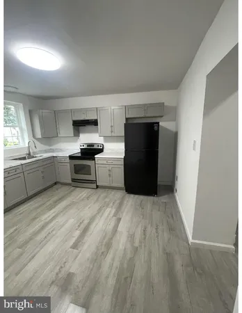 a kitchen with stainless steel appliances a stove a refrigerator sink and cabinets