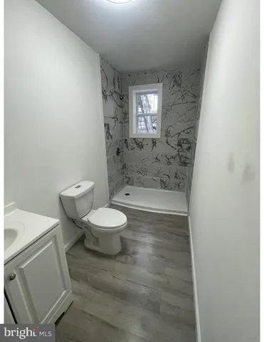 a bathroom with a toilet and a shower