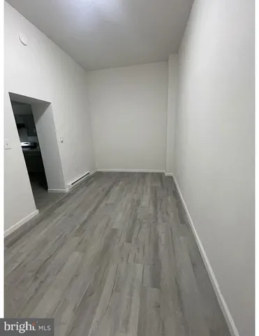 an empty room with wooden floor