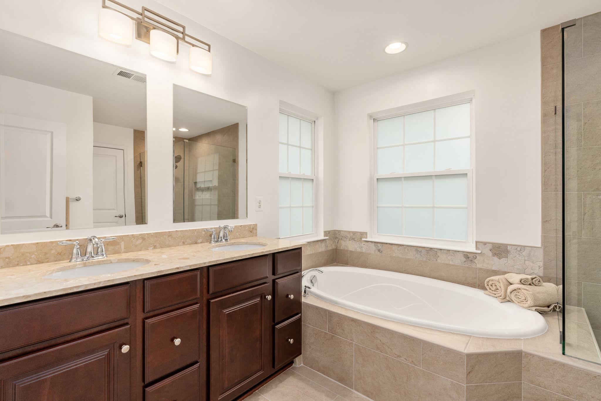 9417 Reservoir Road Fredericksburg, VA 22407 - Photo 62 of 76 a bathroom with a large tub sink and vanity