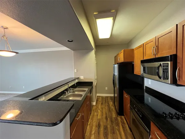 a kitchen with stainless steel appliances a stove a microwave and a refrigerator