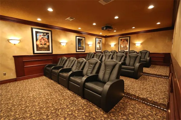 a media room with lots of chairs and a rug
