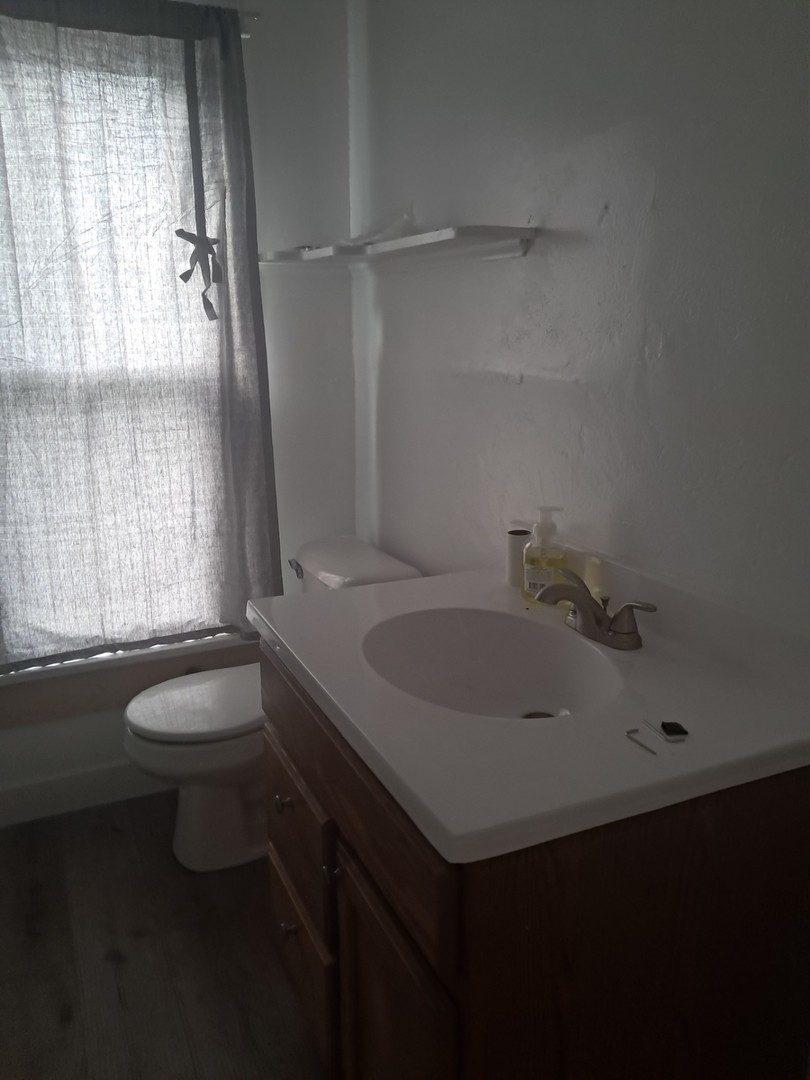 507 6th Avenue Sterling, IL 61081 - Photo 8 of 12 a bathroom with a sink and a toilet
