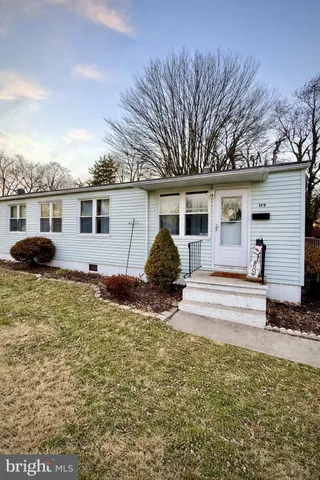 a view of a house with backyard and trees
