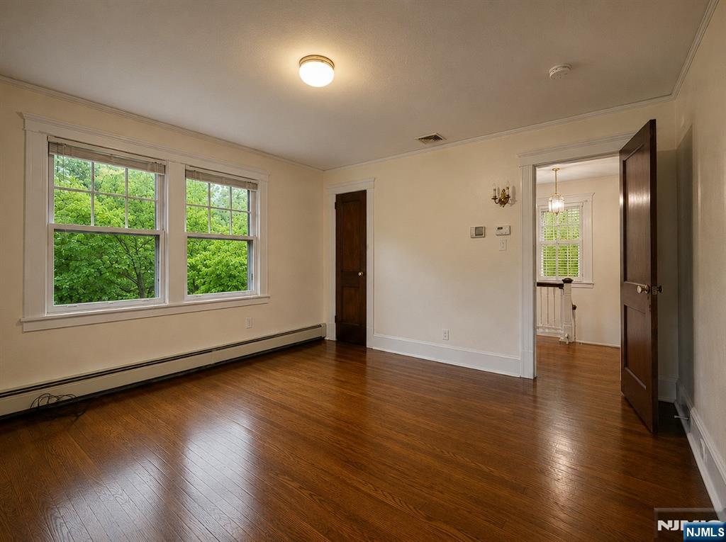 84 Valley View Avenue Ridgewood, NJ 07450 - Photo 14 of 20 an empty room with wooden floor and windows