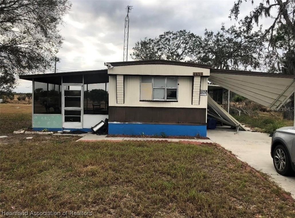 3413 Baxter Avenue Sebring, FL 33870 - Photo 1 of 1 a view of a house with a backyard and garage