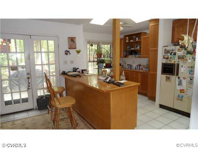 12141 Spring Run Road Chesterfield, VA 23832 - Photo 2 of 6 a kitchen with a table chairs and entryway