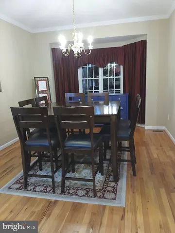 a kitchen with stainless steel appliances granite countertop a sink a stove counter space and wooden floor