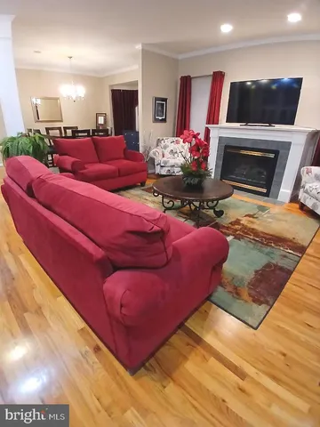 a living room with granite countertop furniture and a chandelier