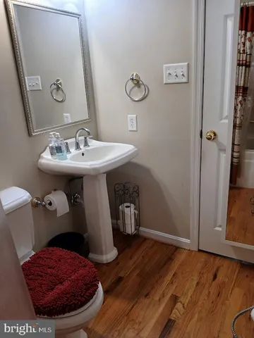 a view of a hallway view with wooden floor and staircase