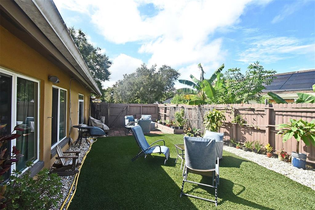 31 Chip Court Kissimmee, FL 34759 - Photo 11 of 37 a view of a chair and tables in backyard of the house