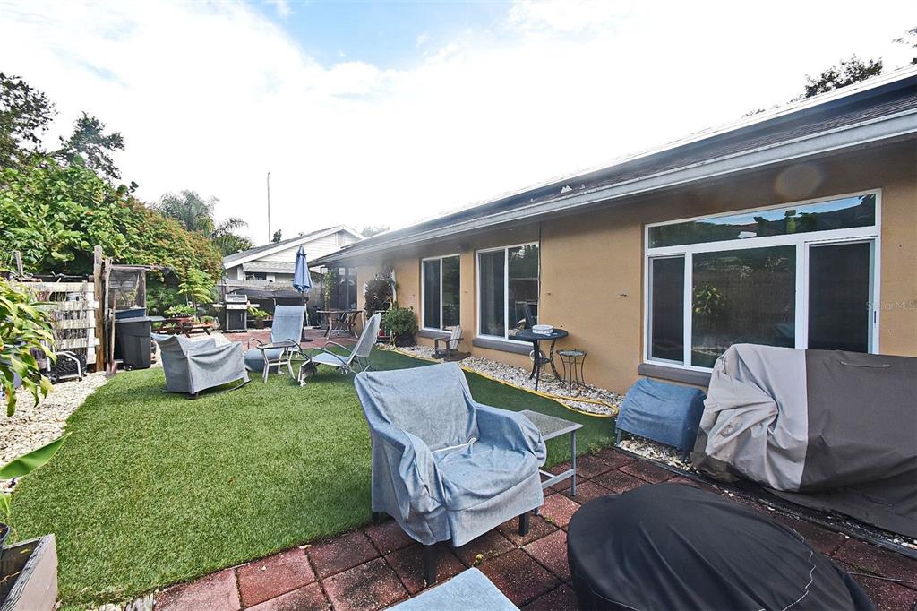 31 Chip Court Kissimmee, FL 34759 - Photo 13 of 37 a view of a patio with couches table and chairs with garden view
