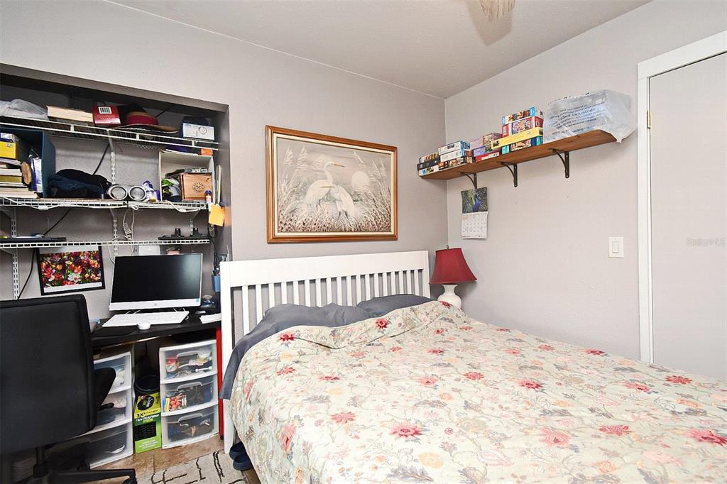 31 Chip Court Kissimmee, FL 34759 - Photo 17 of 37 a bedroom with a bed and a book shelf