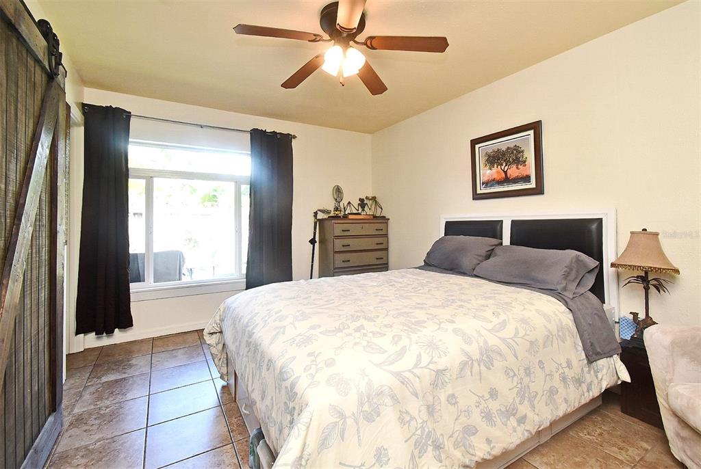 31 Chip Court Kissimmee, FL 34759 - Photo 20 of 37 a spacious bedroom with a bed and a chandelier