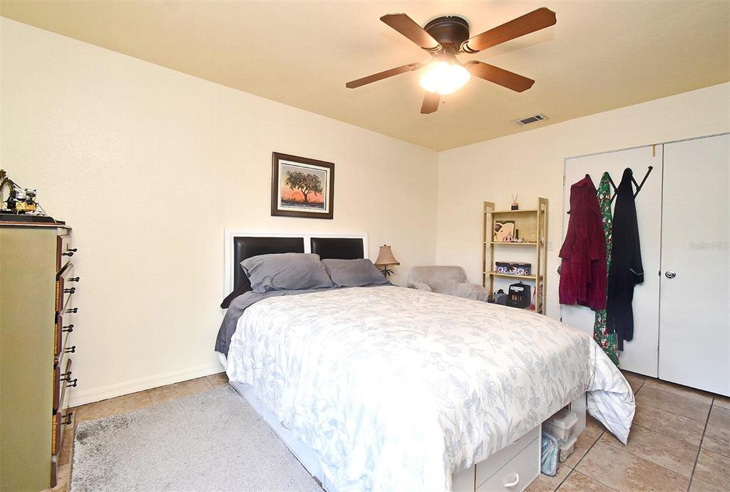 31 Chip Court Kissimmee, FL 34759 - Photo 21 of 37 a bedroom with a bed and a chandelier