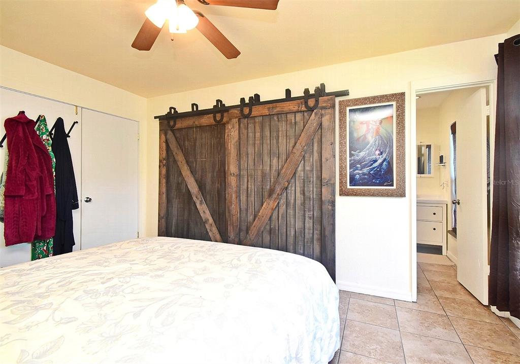 31 Chip Court Kissimmee, FL 34759 - Photo 22 of 37 a bed room with a bed and a walk in closet
