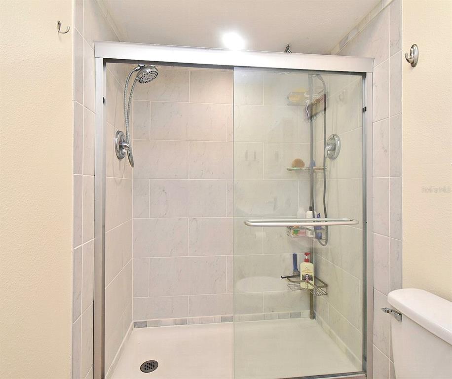 31 Chip Court Kissimmee, FL 34759 - Photo 23 of 37 a bathroom with a glass shower door