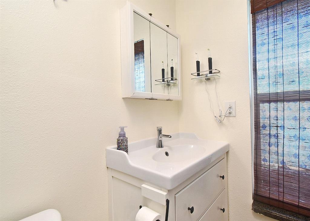 31 Chip Court Kissimmee, FL 34759 - Photo 24 of 37 a bathroom with a sink a toilet and shower