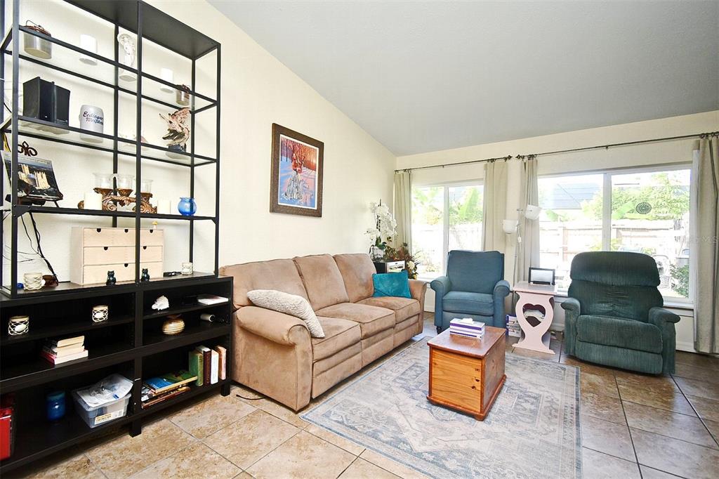 31 Chip Court Kissimmee, FL 34759 - Photo 31 of 37 a living room with furniture and floor to ceiling window