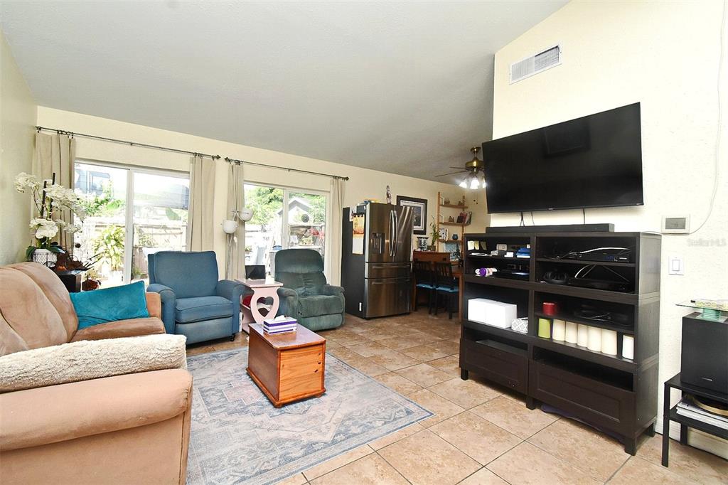 31 Chip Court Kissimmee, FL 34759 - Photo 32 of 37 a living room with furniture and a flat screen tv