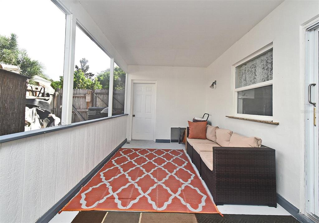 31 Chip Court Kissimmee, FL 34759 - Photo 9 of 37 a living room with a large window with outer view and couch