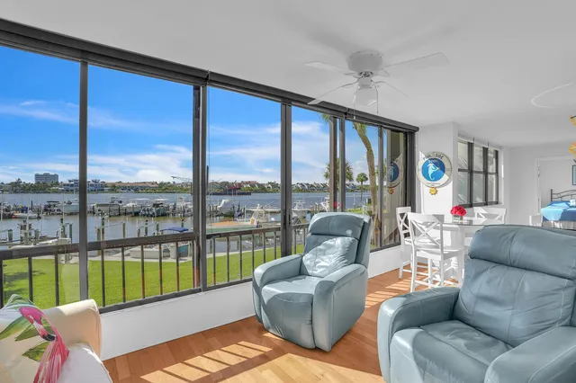 a living room with furniture and a floor to ceiling window