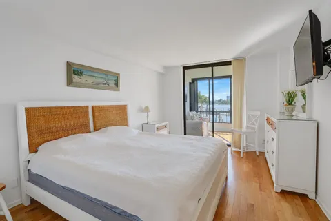 a bedroom with a bed and a flat screen tv