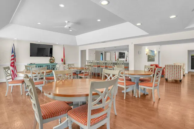 a dining room with lots of furniture and wooden floor