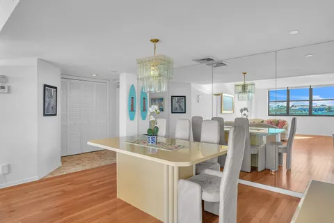 a view of a dining room with furniture a chandelier and wooden floor