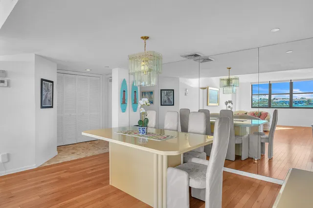 a view of a dining room with furniture a chandelier and wooden floor