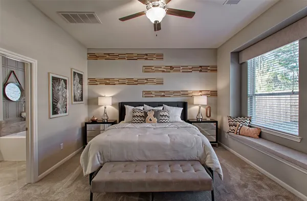 a bedroom with a bed and a ceiling fan