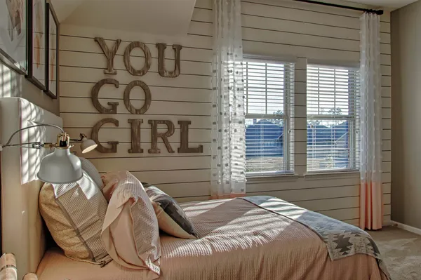 a bed room with a bed and a chair