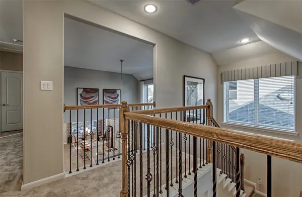 a view of a hallway to a livingroom with furniture