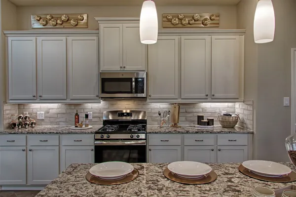 a kitchen with stainless steel appliances granite countertop a sink and cabinets