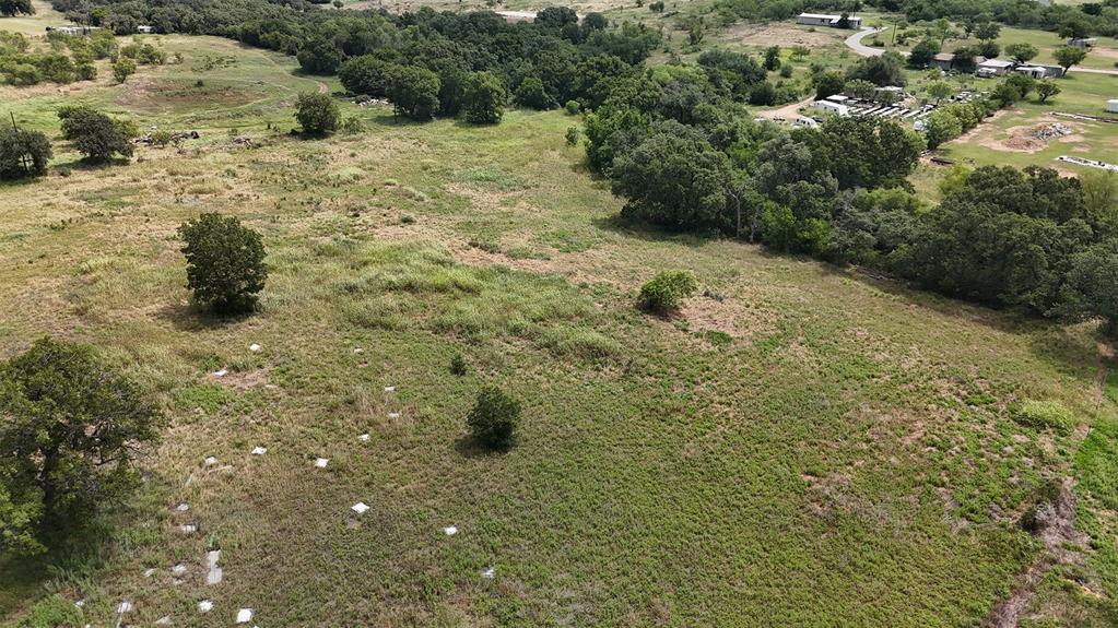 497 Big Sandy Road Newcastle, TX 76372 - Photo 7 of 22 Expansive open land with varied topography, featuring scattered mature trees and natural vegetation