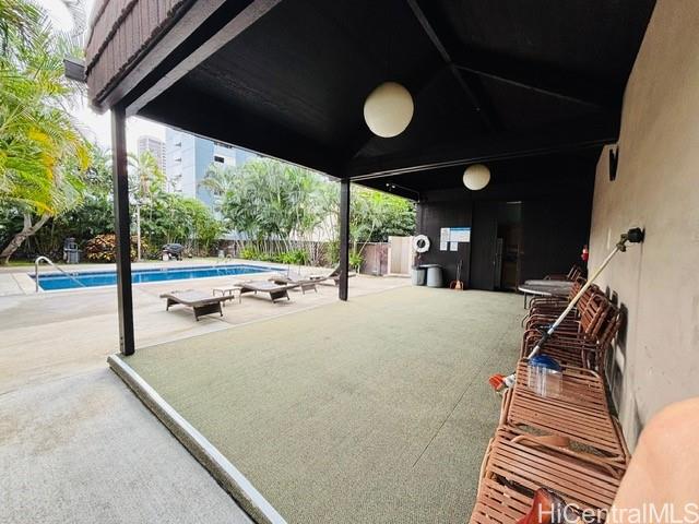 775 Kinalau Place, Unit 2008 Honolulu, HI 96813 - Photo 13 of 14 a view of a patio with table and chairs