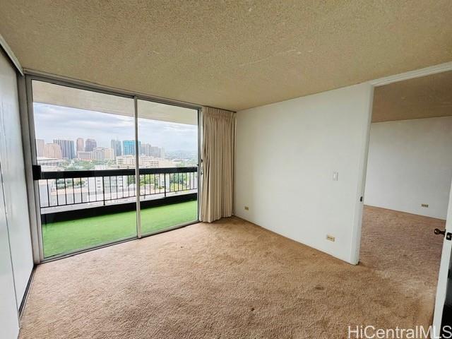 775 Kinalau Place, Unit 2008 Honolulu, HI 96813 - Photo 8 of 14 a view of a room with furniture and a large window