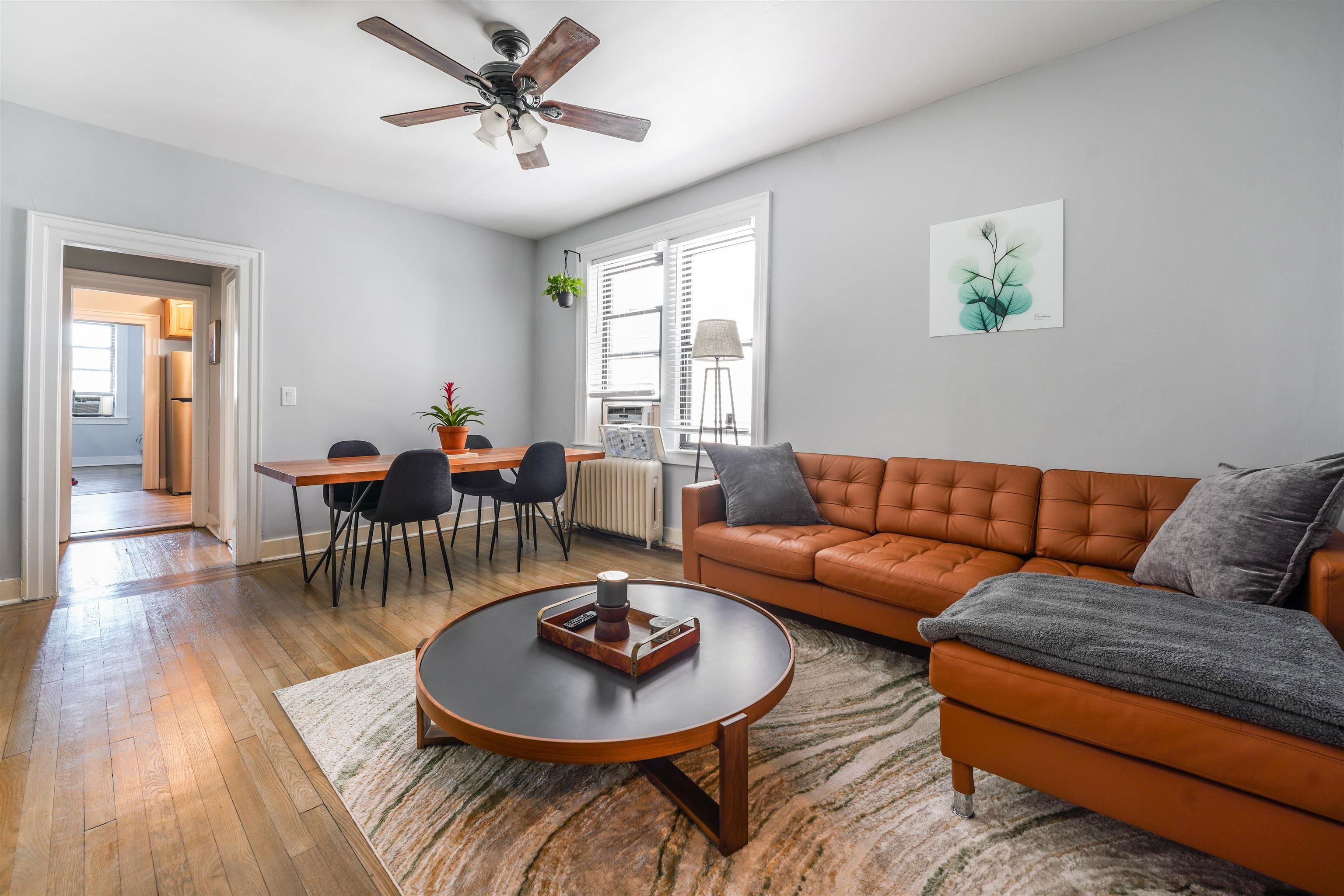 331 79th Street, Unit 53 North Bergen, NJ 07047 - Photo 2 of 14 a living room with furniture and a wooden floor