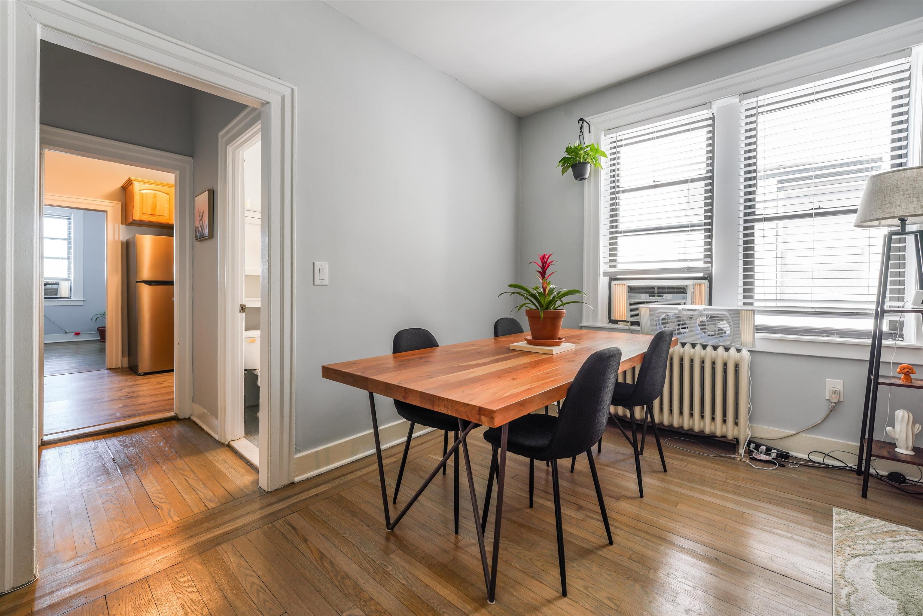 331 79th Street, Unit 53 North Bergen, NJ 07047 - Photo 4 of 14 a dining room with furniture and wooden floor