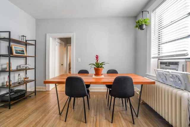 a dining room with furniture and wooden floor