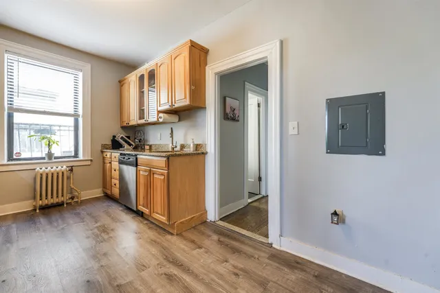 a kitchen with granite countertop a stove a sink and a refrigerator
