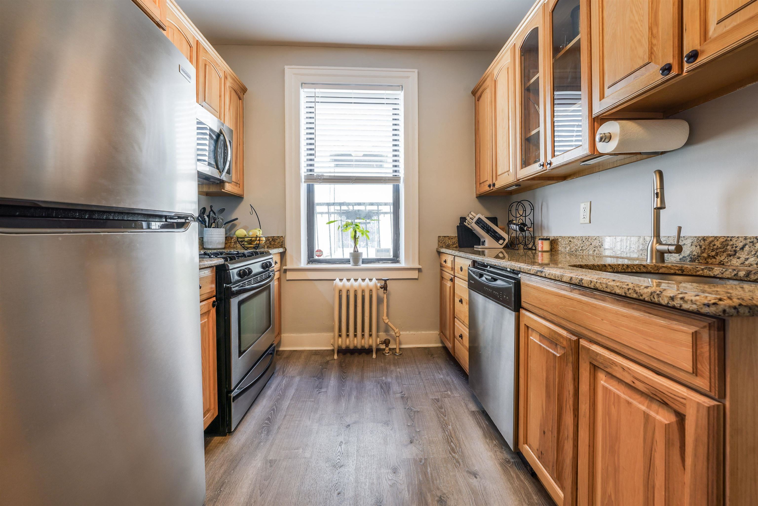 331 79th Street, Unit 53 North Bergen, NJ 07047 - Photo 7 of 14 a kitchen with a refrigerator a sink and wooden floor