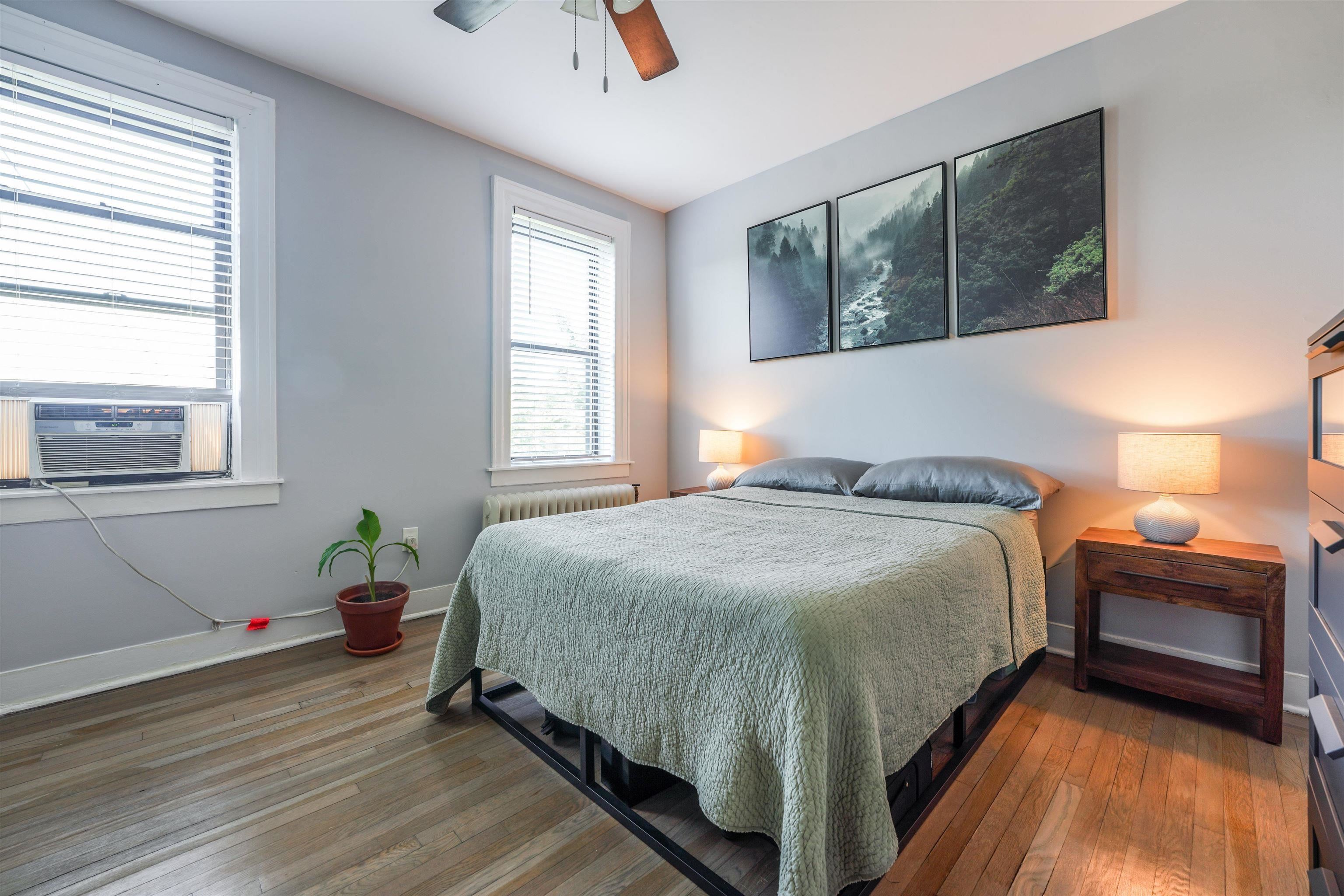 331 79th Street, Unit 53 North Bergen, NJ 07047 - Photo 8 of 14 a bedroom with a bed and wooden floor