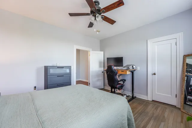 a bedroom with a bed and wooden floor