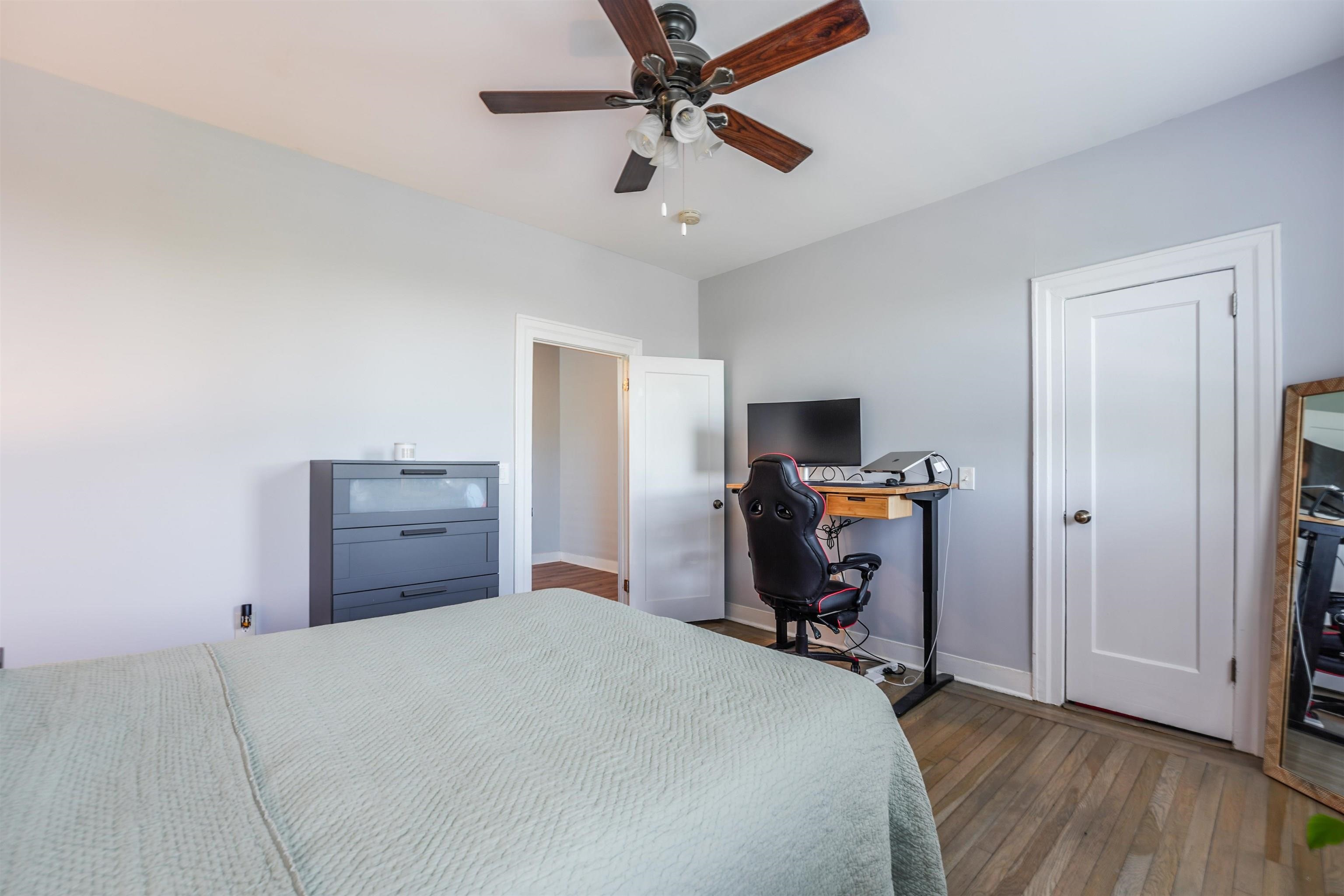 331 79th Street, Unit 53 North Bergen, NJ 07047 - Photo 9 of 14 a bedroom with a bed and wooden floor
