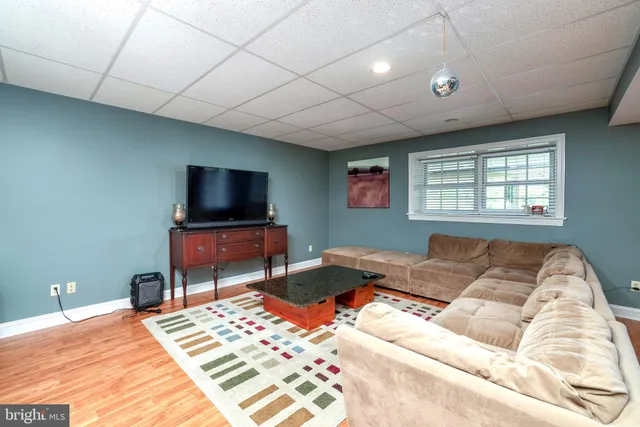a kitchen with stainless steel appliances a dining table chairs and wooden floor