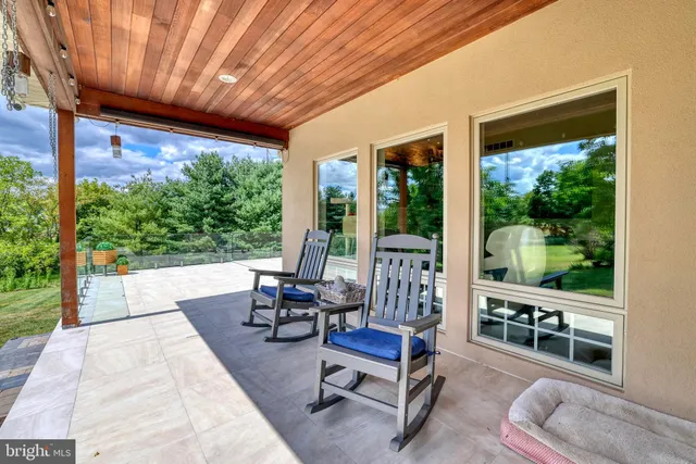 a view of backyard with outdoor seating and plants