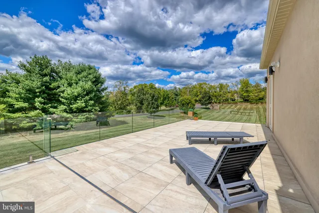 a front view of a house with a yard and potted plants